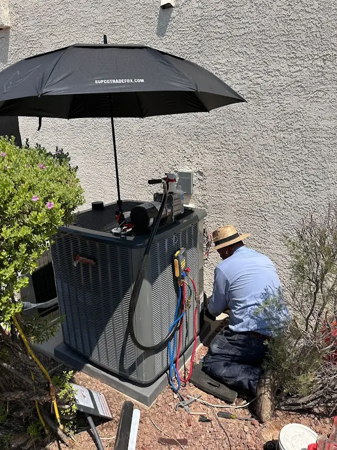 HVAC technician performing outdoor AC maintenance in Gary